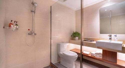 a bathroom with a shower and a toilet and a sink at Borrman Hotel Liuzhou High-Speed Railway Station in Liuzhou