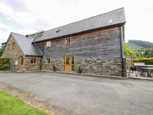 a large brick building with a table in front of it at The Hayloft in Knighton