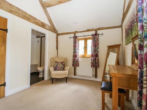 a home office with a chair and a desk at The Hayloft in Knighton