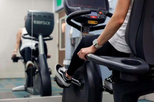 a person riding an exercise bike in a gym at Holiday Inn Express San Jose Costa Rica Airport by IHG in Alajuela City