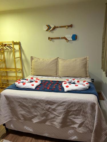 a bed with two hello kitty pillows on it at Canoa Ilha Grande in Abraão