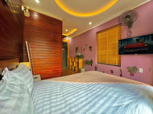 a bedroom with a large bed in a room at Pine Forest House Dalat in Xuan An