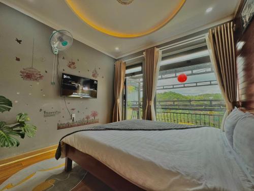 a bedroom with a bed and a window at Pine Forest House Dalat in Xuan An
