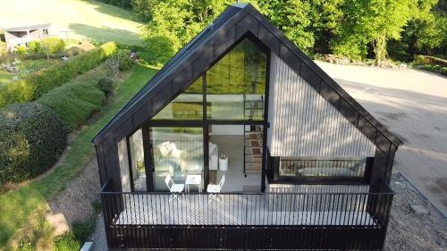 an overhead view of a small house with a large window at Toi-t et moi, Charming penthouse, view et nature in Malmedy