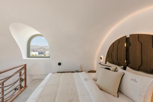 Ένα ή περισσότερα κρεβάτια σε δωμάτιο στο Acro Caldo Suites