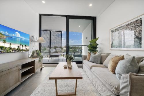 a living room with a couch and a table at Chic 1-Bed Escape in Fremantle with Parking in North Fremantle