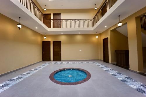 an empty room with a swimming pool in the middle of the floor at Jashn Wellness Resort Lucknow in Lucknow