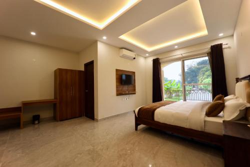 a bedroom with a bed and a large window at Jashn Wellness Resort Lucknow in Lucknow