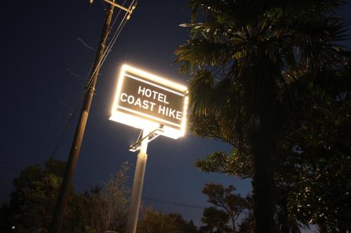 a sign that reads hotel coast hike at night at COAST HIKE BEACH HOTEL in Sosa