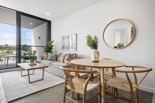 a living room with a table and a couch at Chic 1-Bed Escape in Fremantle with Parking in North Fremantle