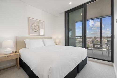a bedroom with a large bed and a large window at Bright 1-Bedroom Escape with Private BBQ in North Fremantle