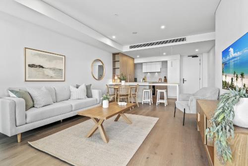 a living room with a couch and a table at Stylish 2-Bed Unit with Views & Rooftop Access in North Fremantle