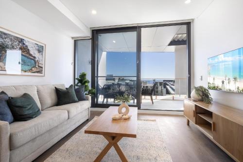 a living room with a couch and a table at Penthouse Stay With Ocean Views in North Fremantle