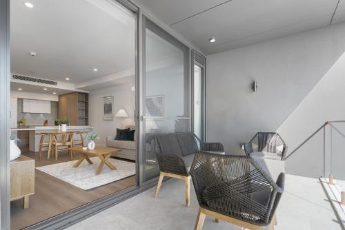 a living room with chairs and a table at Penthouse Stay With Ocean Views in North Fremantle