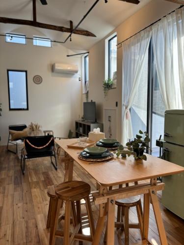 a dining room with a wooden table and chairs at Near JR Kameari Tokyo - Shades of Green - Japanese House for up to 6 Guests in Tokyo