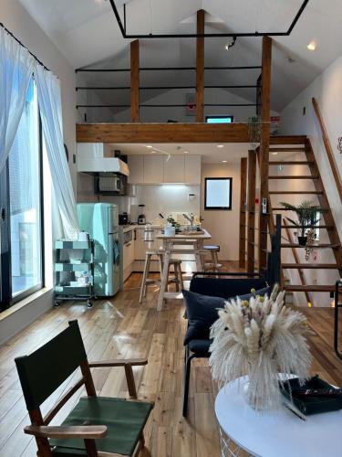 a living room with a table and chairs and a kitchen at Near JR Kameari Tokyo - Shades of Green - Japanese House for up to 6 Guests in Tokyo