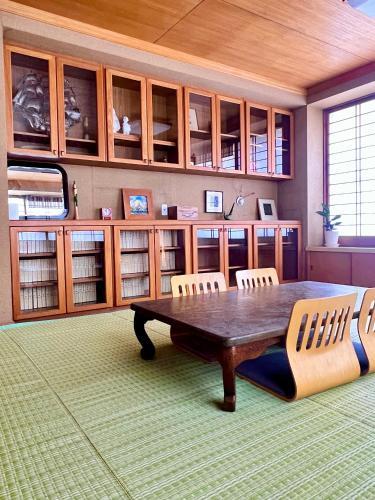 a large room with a wooden table and chairs at Traditional Japanese House, MtFuji view ,Free bag ,4 bedrooms ,Rent bike in Fujiyoshida