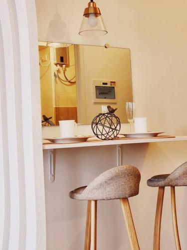 a counter with two stools in front of a mirror at Preum Properties Tagaytay in Tagaytay