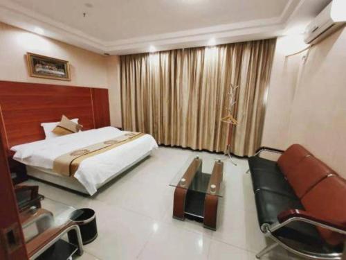 Postel nebo postele na pokoji v ubytování Wanxiang Hotel