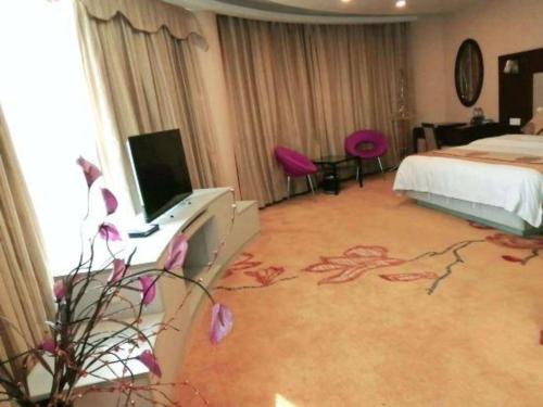 Postel nebo postele na pokoji v ubytování Wanxiang Hotel