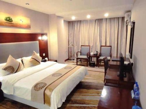 Postel nebo postele na pokoji v ubytování Wanxiang Hotel