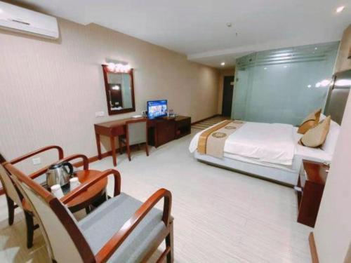 Postel nebo postele na pokoji v ubytování Wanxiang Hotel