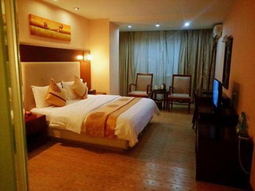 Postel nebo postele na pokoji v ubytování Wanxiang Hotel