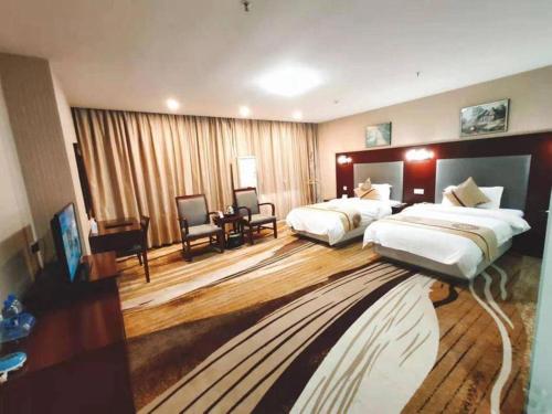 Postel nebo postele na pokoji v ubytování Wanxiang Hotel