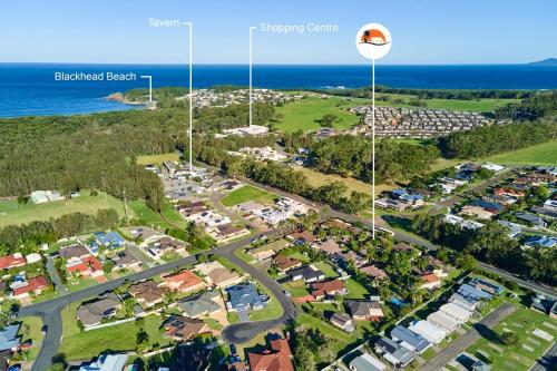 an aerial view of a suburb with the ocean in the background at Kingfisher Apartment in Hallidays Point