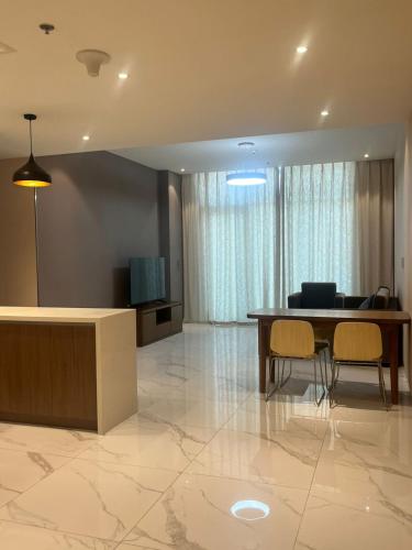 a living room with a dining room table and chairs at EC Holiday Homes Dubai Al Furjan in Dubai