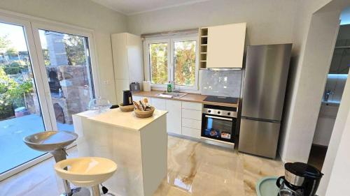 a kitchen with a refrigerator and a stove top oven at Heavens View in Pyrgi
