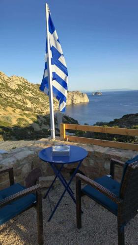 a blue table and two chairs and a flag at Heavens View in Pyrgi