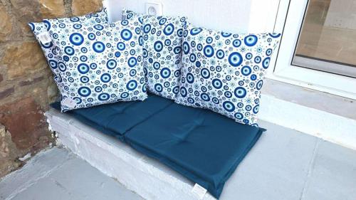 two pillows are sitting on a window sill at Heavens View in Pyrgi