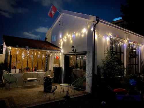 a house with lights on the side of it at night at Loft 90m2 avec spa chauffé unique à Lyon in Lyon