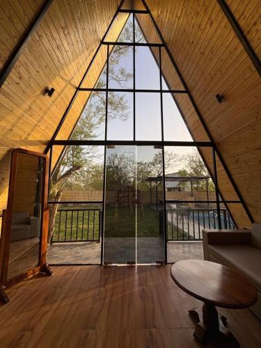 a large window in a room with a couch and a table at Dunewood Resorts in Ani