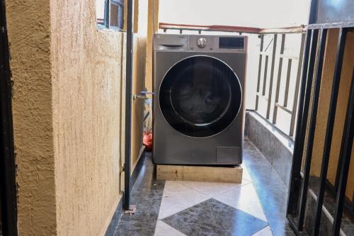 a washing machine is sitting in a doorway at Zedek Suites in Nairobi
