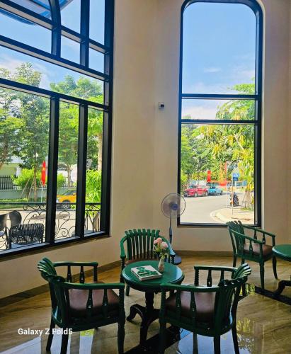 a room with a table and chairs and windows at Swan Boutique Hotel in Ho Chi Minh City