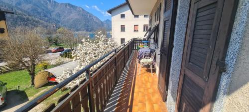 a balcony with a view of a house and flowers at Bioledro - Casa Lena in Mezzolago