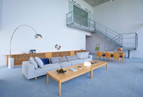 a living room with a couch and a table at SETOUCHI RETREAT by Onko Chishin in Matsuyama