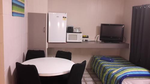 a small room with a table and a microwave at Herbert Valley Motel in Ingham