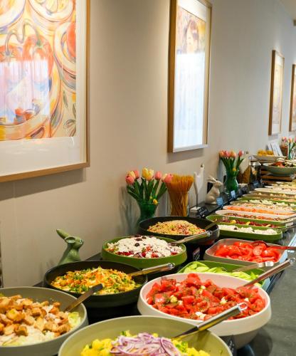 a buffet filled with many different types of food at Kamengrad Hotel & SPA in Panagyurishte