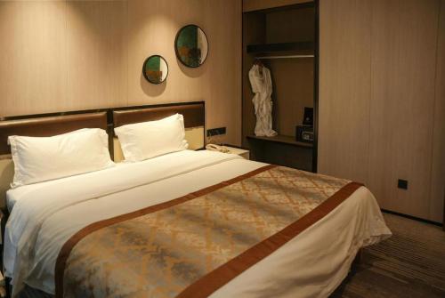 a bedroom with a large bed in a hotel room at Golden Central Hotel Shenzhen in Shenzhen