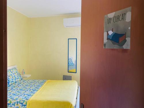 a bedroom with a bed and a wall with a mirror at SoverHouse guest house a Soverato Marina in Soverato Marina