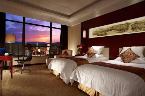 Katil atau katil-katil dalam bilik di New Century Hotel Zaozhuang Fengming