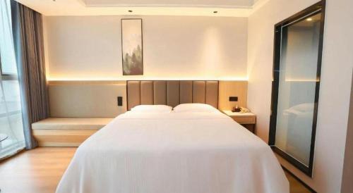 Ένα ή περισσότερα κρεβάτια σε δωμάτιο στο GreenTree Inn Maanshan Hanshan District Jiuwu Square Hotel
