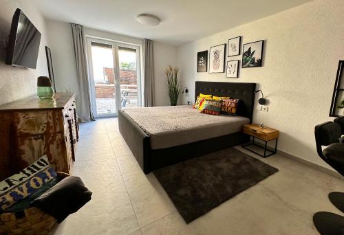 a bedroom with a bed and a large window at Komarna Coastal Retreat With Sea Views in Komarna