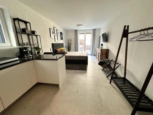 a room with a bed and a staircase in it at Komarna Coastal Retreat With Sea Views in Komarna