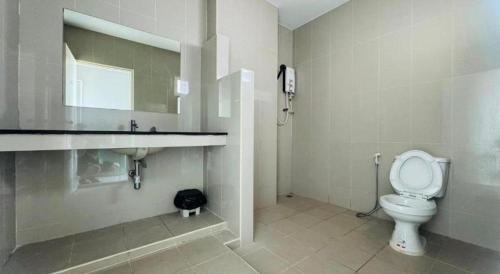 a bathroom with a toilet and a sink at River Residence Saraburi Hotel in Sara Buri