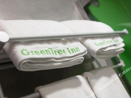 a shelf with white towels with the words greeter inn at GreenTree Inn Yancheng Yandu District Hongxing Macalline Century Avenue in Yancheng