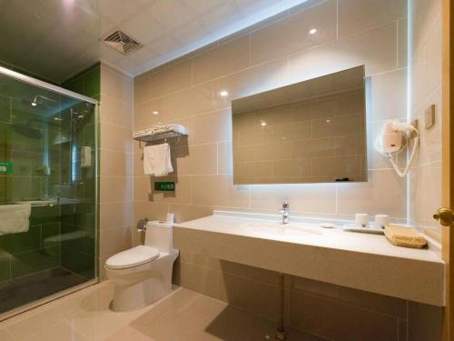 a bathroom with a toilet and a sink and a shower at GreenTree Inn Qinhuangdao Changli County Guangyuan Life Square Duanyang Street East Section in Qinhuangdao
